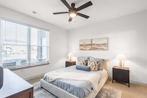 Franklin apartment for rent - A bedroom with a bed, two lamps, and a painting on the wall.