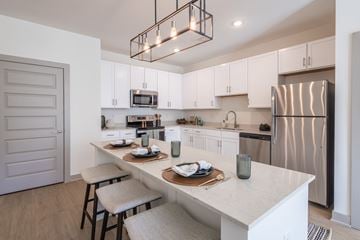 Louisville apartment for rent - A modern kitchen with a white countertop and stainless steel appliances.