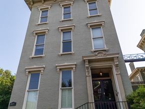 Louisville apartment for rent - A tall building with a balcony and a doorway on the ground floor.