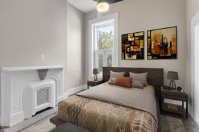 Louisville apartment for rent - A bedroom with a large bed and a fireplace.