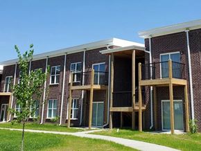 Louisville apartment for rent - A row of red brick apartment buildings with balconies.