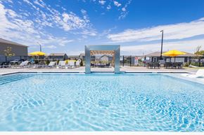 Whiteland apartment for rent - A large swimming pool with a blue tinted water and a white diving board.