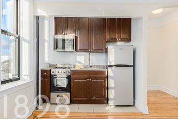 Woodside apartment for rent - A kitchen with a stove, oven, and refrigerator.