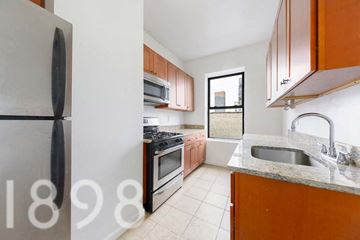Sunnyside apartment for rent - A kitchen with a refrigerator, sink, and stove.