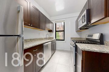 Sunnyside And Long Island City apartment for rent - A kitchen with brown cabinets and a stainless steel refrigerator.