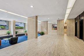 New York apartment for rent - A spacious office hallway with wooden floors and columns.