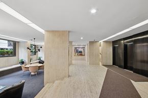 New York apartment for rent - A modern office space with a long hallway and a meeting room.