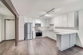 San Francisco apartment for rent - an empty kitchen with white cabinets and stainless steel appliances
