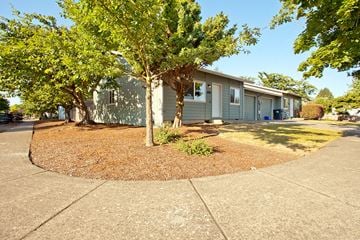 Eugene triplex for rent - a blue house with trees in front of it