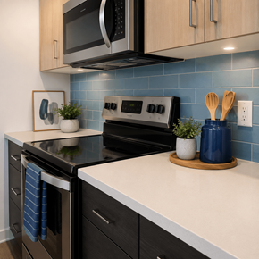 Junction City townhouse for rent - A kitchen with a black oven and a black microwave above it.