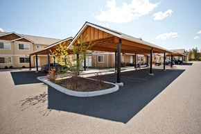 Bend townhouse for rent - a parking lot with a building in the background