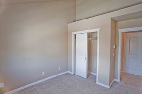 Bend townhouse for rent - a bedroom with a closet and a door to a hallway