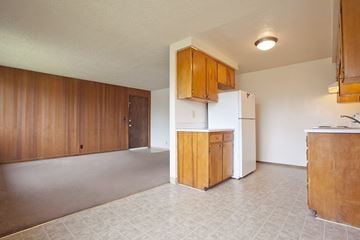 Springfield apartment for rent - A kitchen with white appliances and wooden cabinets.