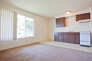Eugene apartment for rent - A kitchen area with a white stove and brown cabinets.