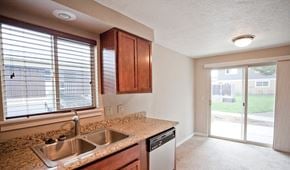 Bend townhouse for rent - an empty kitchen with a sink and a window