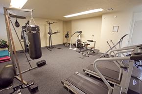 Bend apartment for rent - a gym with a punching bag in the corner of a room