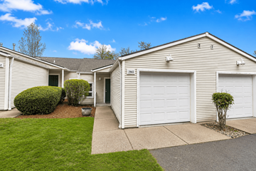 Eugene townhouse for rent - A row of houses with garages and green lawns.