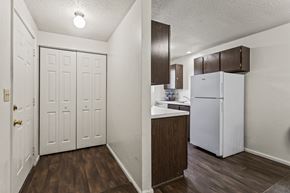 Springfield apartment for rent - A kitchen area with a white refrigerator and brown cabinets.