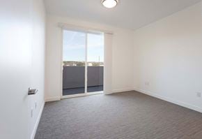 Albuquerque apartment for rent - an empty living room with a door to a balcony