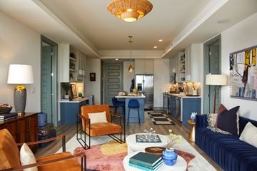 Austin apartment for rent - A living room with a blue couch and a yellow chair.