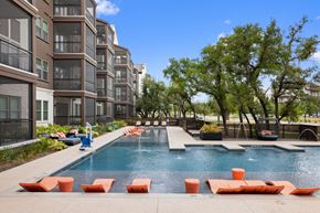 Austin apartment for rent - Pool with orange sun loungers and tree in background