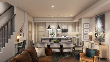 Arlington townhouse for rent - A modern living room with a brown couch and a kitchen in the background.