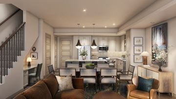 Arlington townhouse for rent - A modern living room with a brown couch and a kitchen in the background.