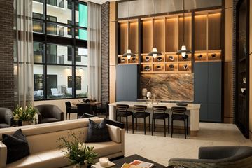 Dallas apartment for rent - A modern living room with a large painting on the wall and a dining table set up.