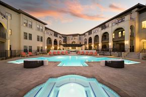 Scottsdale apartment for rent - A large outdoor swimming pool surrounded by a building.