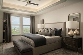 Houston apartment for rent - A bedroom with a large bed and a ceiling fan.