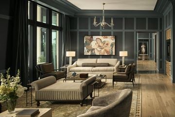 Houston apartment for rent - A living room with a grey couch and a chandelier.