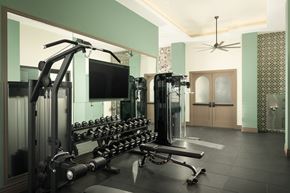 Scottsdale apartment for rent - a fitness center with weights and a tv ceiling fan