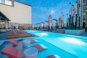 Atlanta apartment for rent - a hotel swimming pool with a city skyline in the background