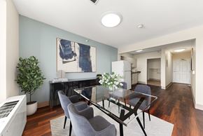 Spokane apartment for rent - A modern dining room with a glass table and grey chairs at 206 Flats Apartments, Spokane