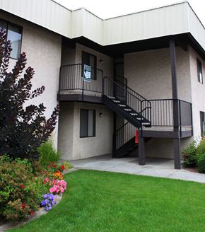 Spokane apartment for rent - A building with a balcony and stairs.