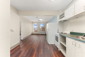 Spokane apartment for rent - A kitchen with white cabinets and a wooden floor at 206 Flats Apartments, Washington