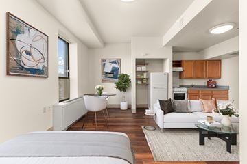 Spokane apartment for rent - A modern living room with a grey sofa and a coffee table.