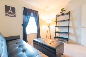 Pontiac apartment for rent - a living room with a leather couch and a