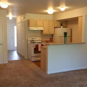 Romulus apartment for rent - a kitchen with a white stove and a refrigerator