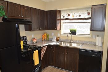 Kitchen with dark wood cabinets and gray countertops