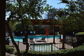 Pool deck with pergola and fenced patio area