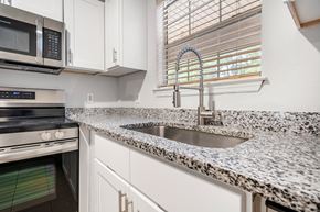 Savannah apartment for rent - A kitchen with a granite countertop and a stainless steel sink.