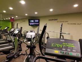 St. Robert townhouse for rent - a room filled with lots of cardio equipment and a flat screen tv