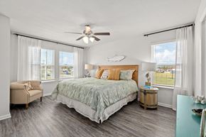 Lynn Haven townhouse for rent - a bedroom with a bed and a ceiling fan