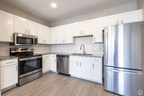 Asheville apartment for rent - a kitchen with stainless steel appliances and white cabinets