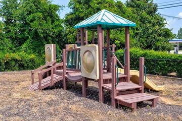 Gainesville apartment for rent - A playground with a green roof and a yellow slide.