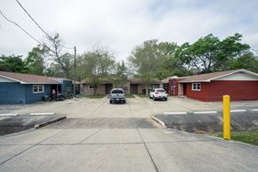 Pensecola apartment for rent - A parking lot with cars and a yellow pole.