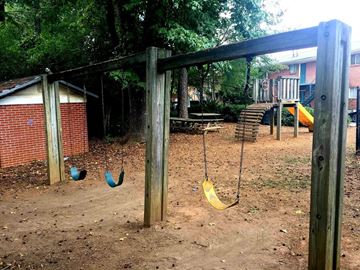 Marietta apartment for rent - A playground with a swing set and a slide.