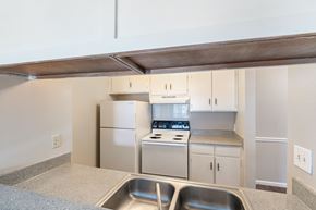 Greensboro apartment for rent - A kitchen with a stove top oven and a sink.