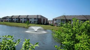Memphis apartment for rent - A fountain in the middle of a lake surrounded by greenery.